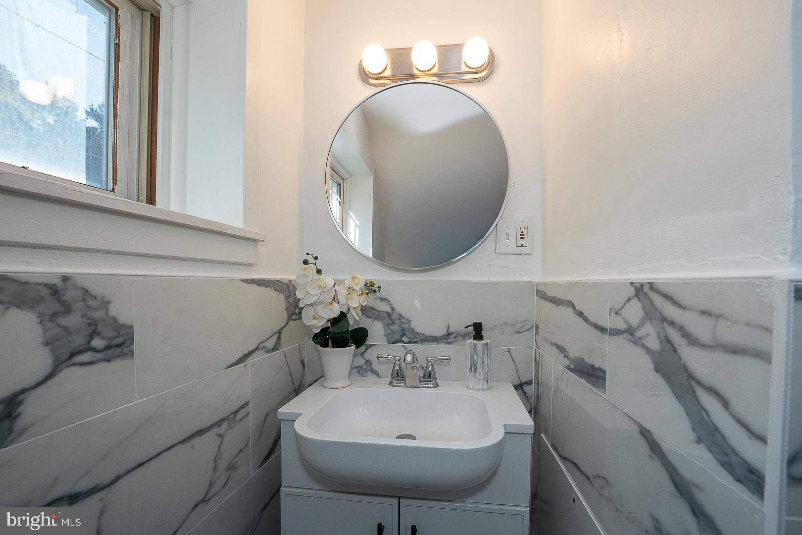 875 Old State Road Berwyn, PA 19312 - Photo 19 of 30 a bathroom with a sink and a mirror