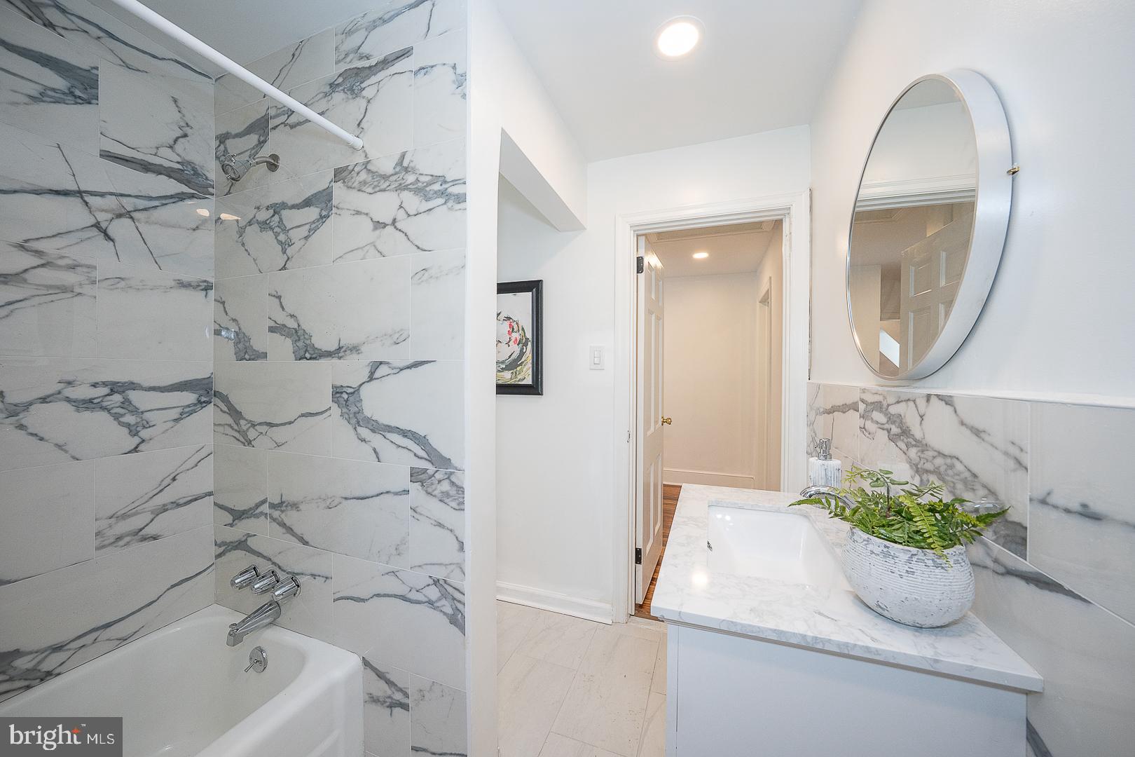 875 Old State Road Berwyn, PA 19312 - Photo 23 of 30 a bathroom with a tub sink and mirror