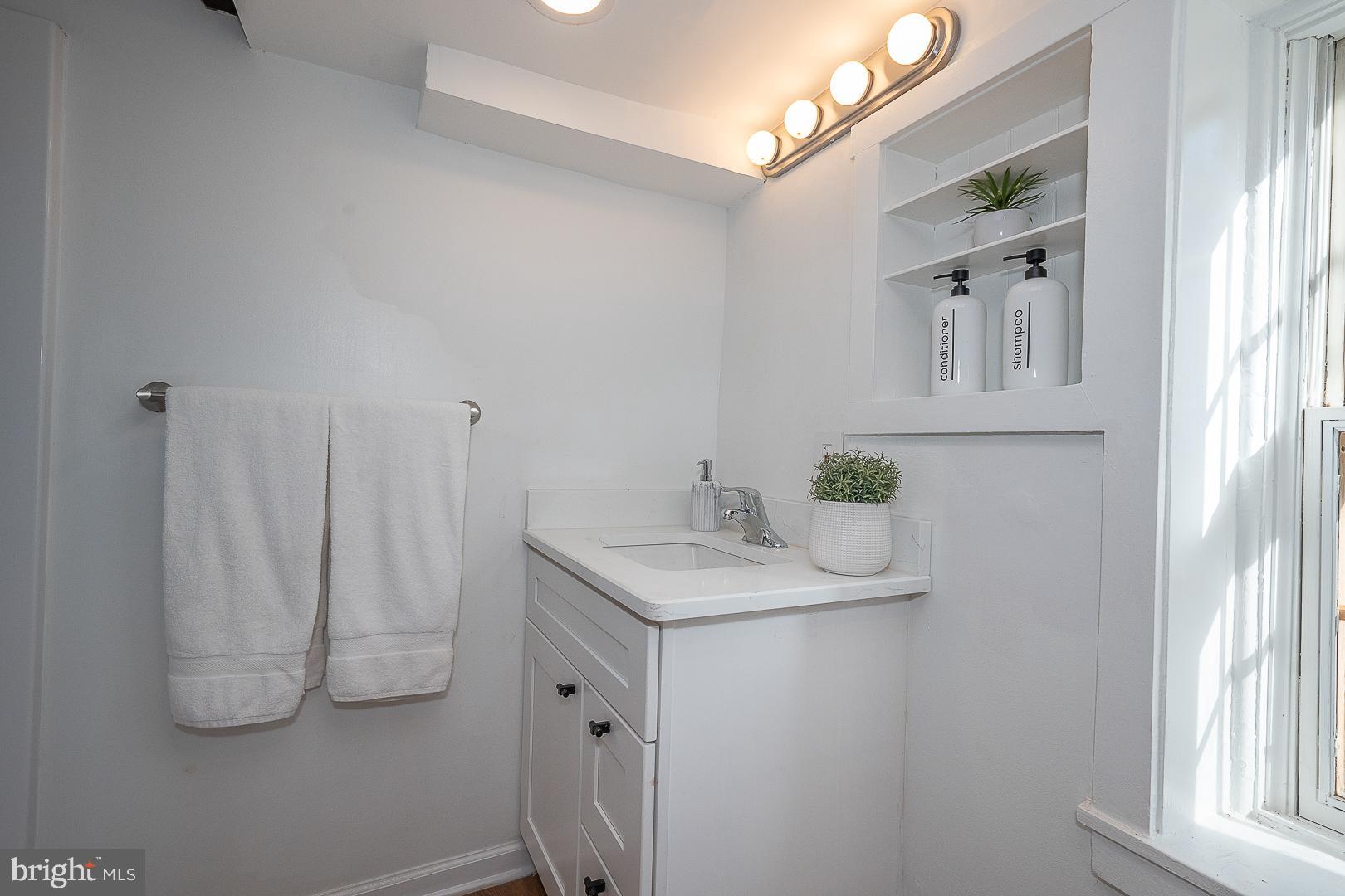 875 Old State Road Berwyn, PA 19312 - Photo 5 of 30 a bathroom with a sink and a mirror