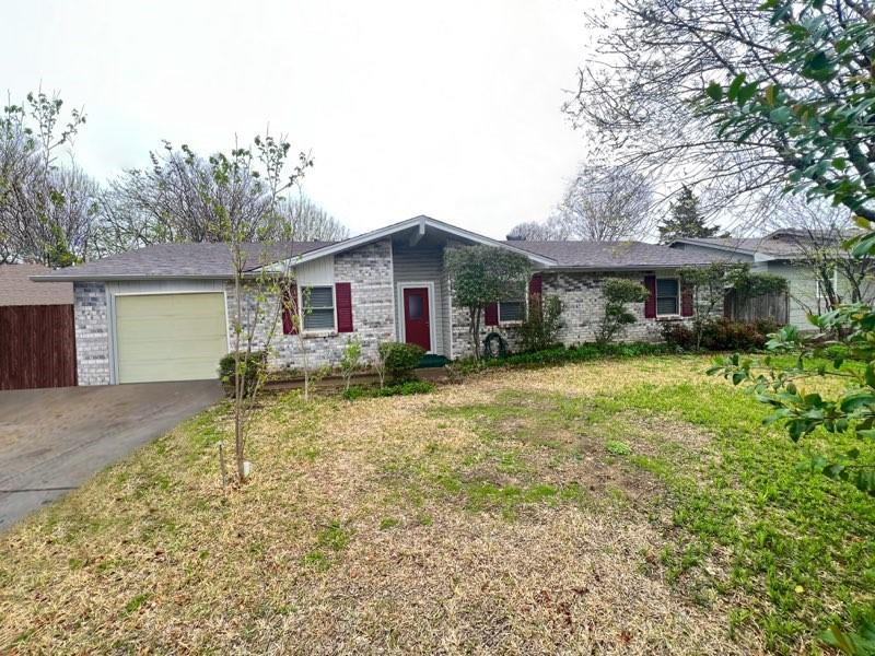 a view of a house with a yard and sitting area