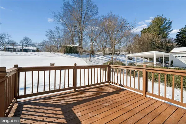 a view of backyard with deck and outdoor seating