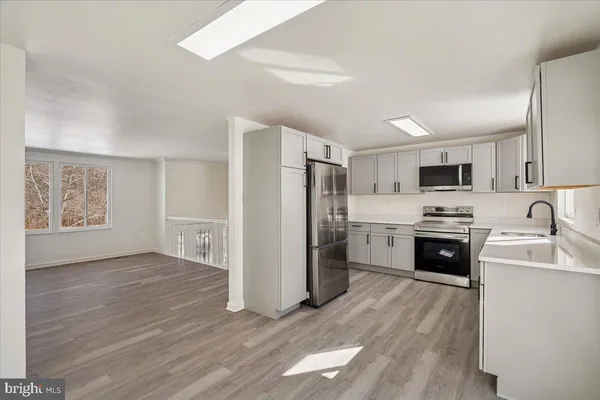 a kitchen with a sink stove and refrigerator