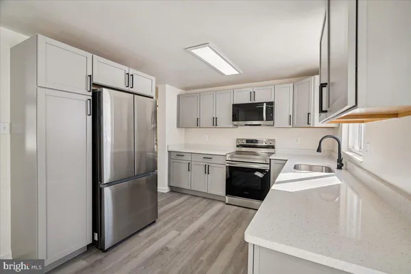 a kitchen with a sink cabinets and window