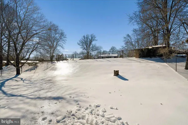 a view of a yard with snow on the road