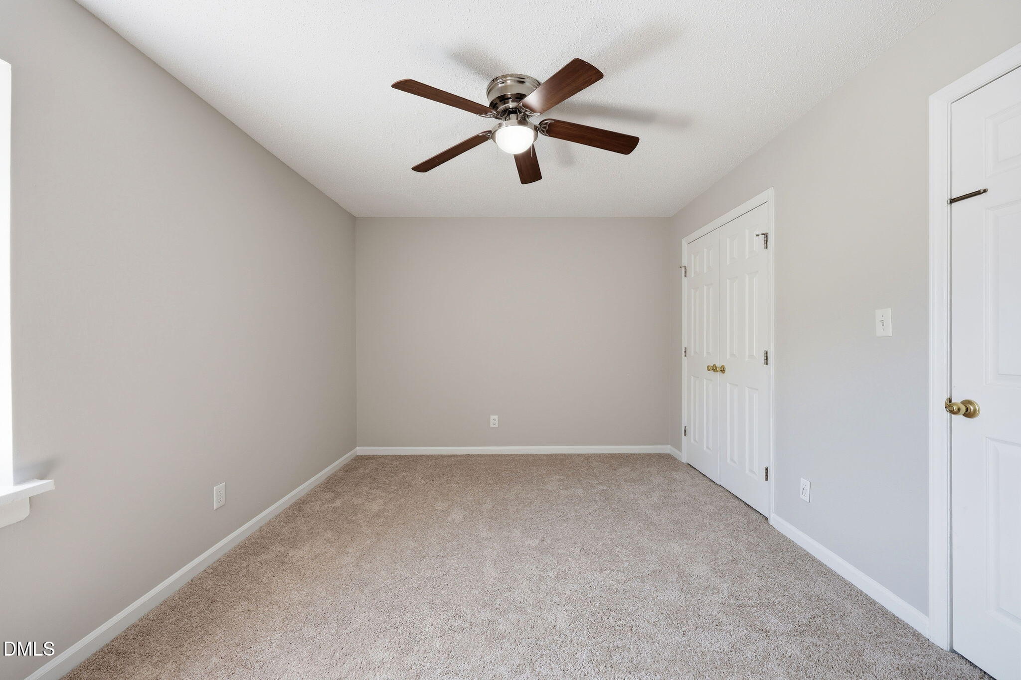 145 Jones Franklin Road, Unit D Raleigh, NC 27606 - Photo 13 of 23 an empty room with ceiling fan and window
