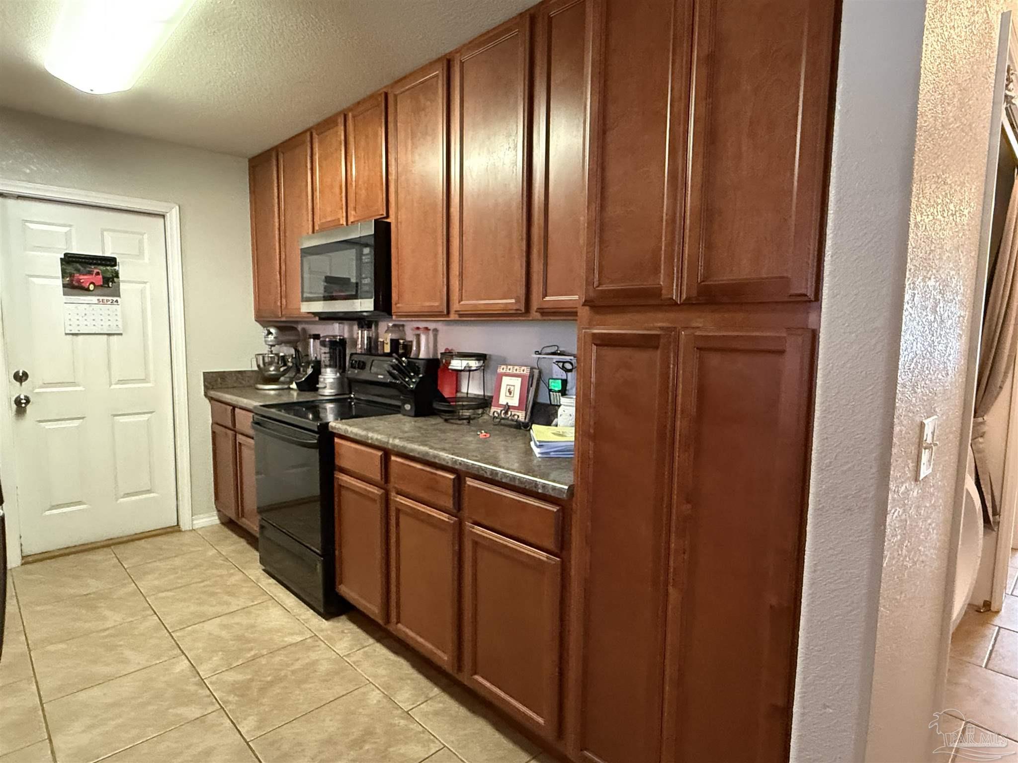 4221 Jernigan Road Pace, FL 32571 - Photo 4 of 11 a kitchen with stainless steel appliances granite countertop a stove a sink and a refrigerator