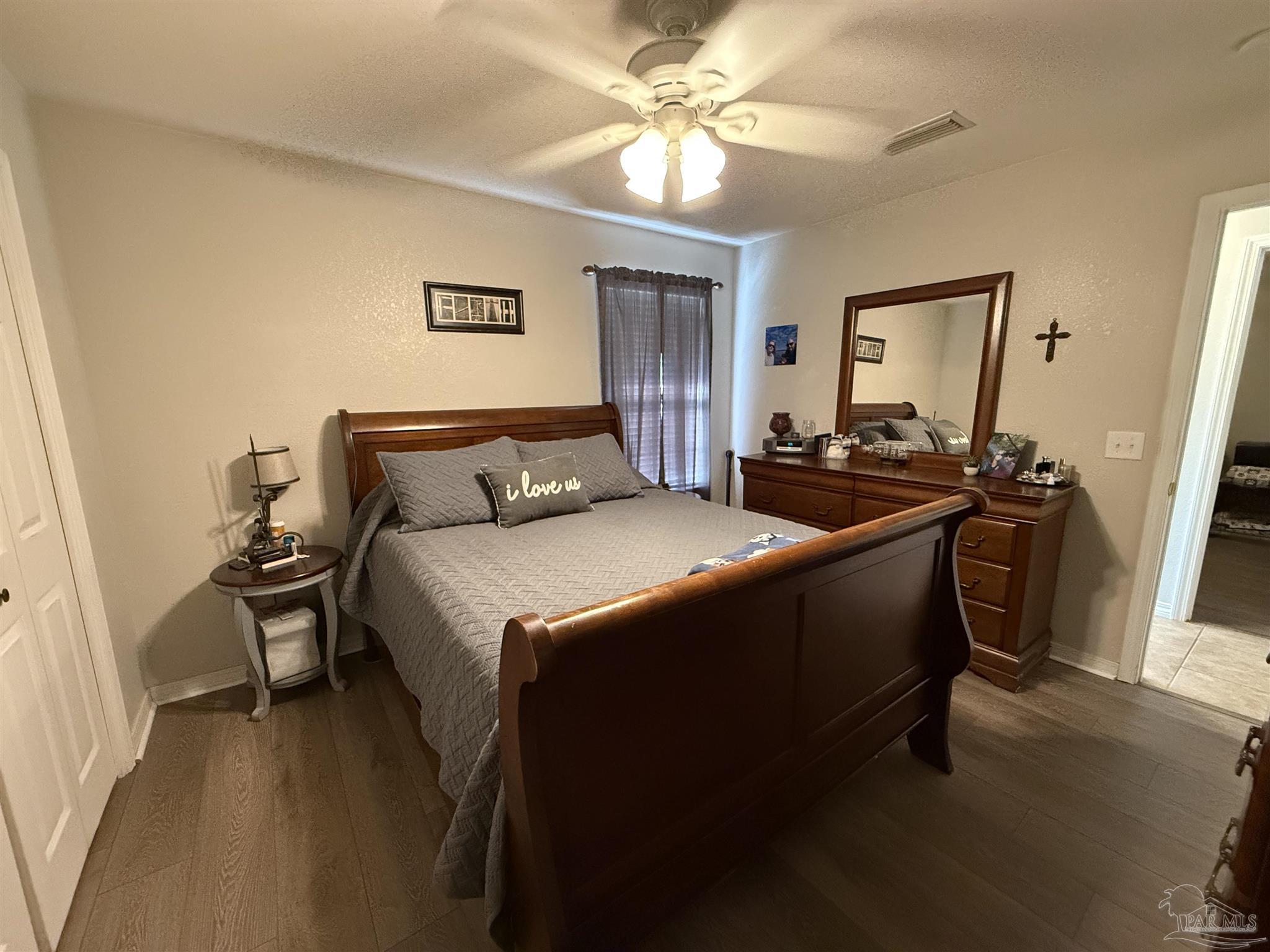 4221 Jernigan Road Pace, FL 32571 - Photo 6 of 11 a bedroom with a bed and a chandelier