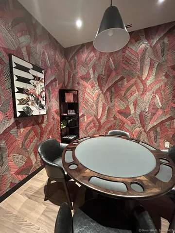 a dining room with furniture and wooden floor