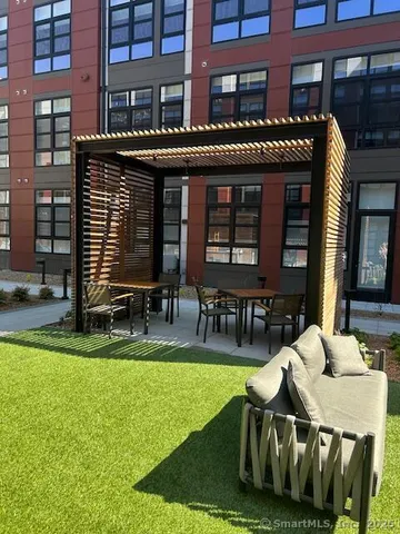 a bathroom with a granite countertop toilet and a sink