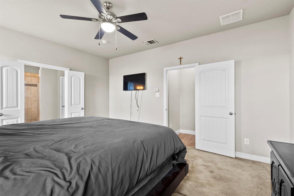 11 Pleasant Valley Sanger, TX 76266 - Photo 12 of 20 a spacious bedroom with a bed and a chandelier