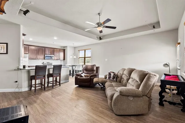 a living room with furniture and kitchen view