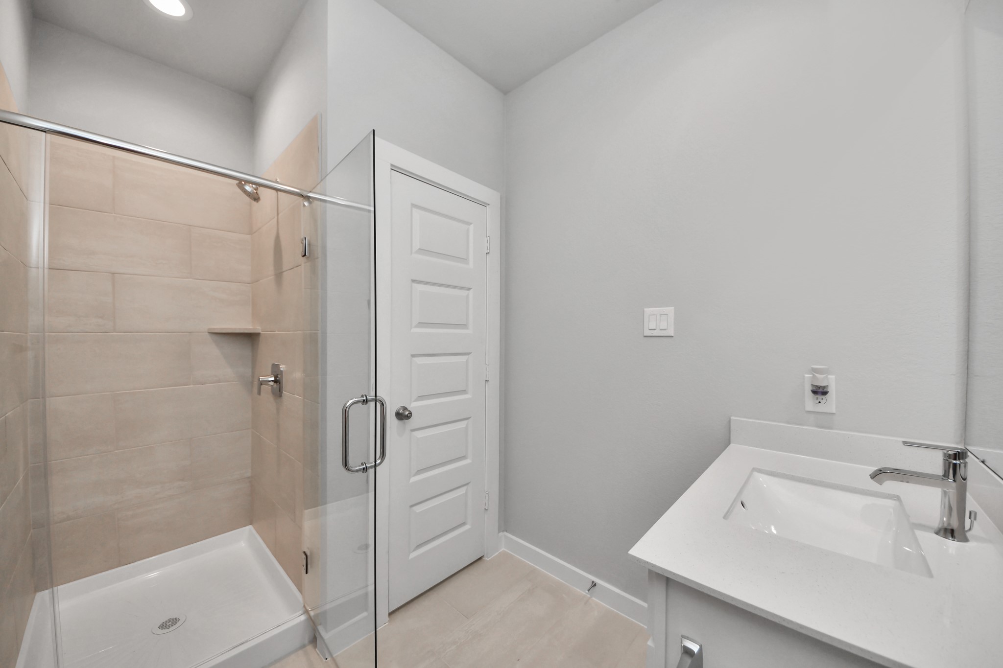 2946 Burris Park Drive Spring, TX 77373 - Photo 9 of 45 Secondary bath features tile flooring, walk-in shower with tile surround, light stained wood cabinets, beautiful light countertop.