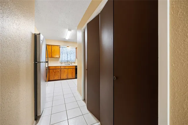 a view of a kitchen with a sink and a refrigerator