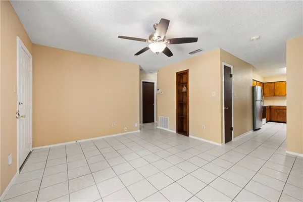 a view of a livingroom with a ceiling fan and window