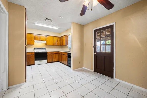 a large white kitchen with a sink