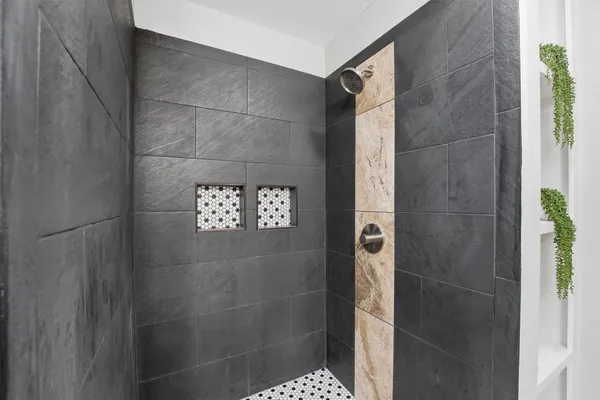 a bathroom with a shower and a sink