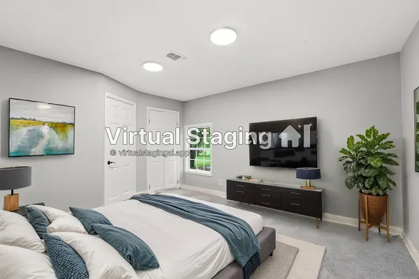 a bedroom with furniture and a flat screen tv