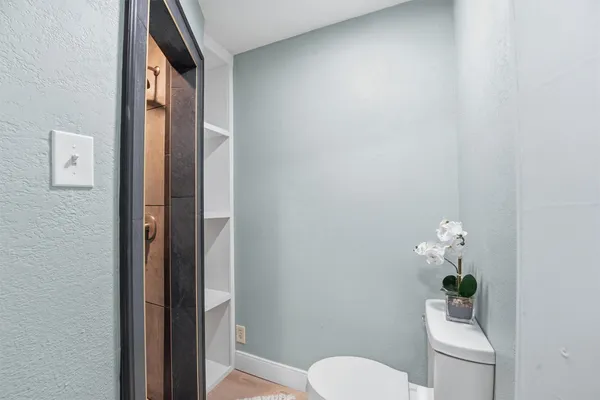 a bathroom with a toilet and a mirror