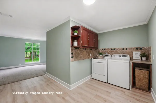 a utility room with sink dryer and washer