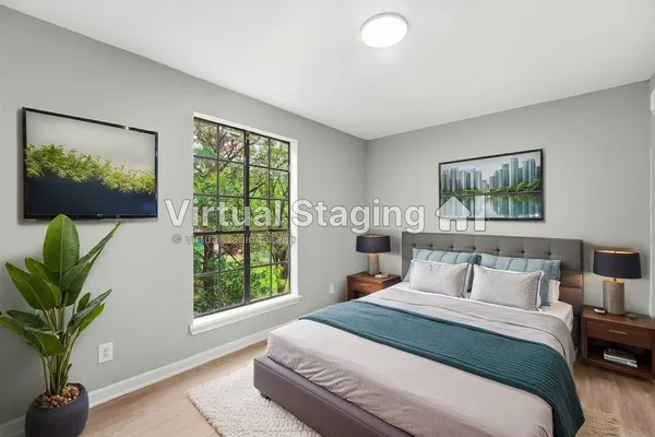 a bedroom with furniture and a large window