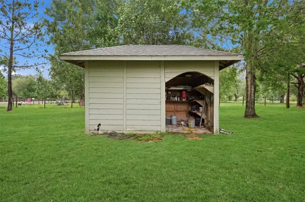 a view of a wooden house with a yard