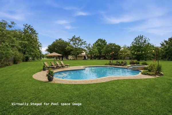 a view of a swimming pool with a yard