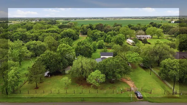 an aerial view of a houses with yard