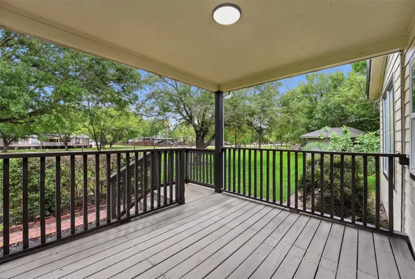 a view of balcony with wooden floor