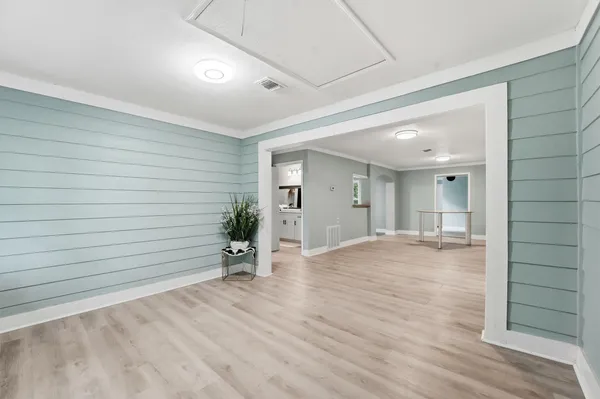 a view of empty room with wooden floor and cabinet