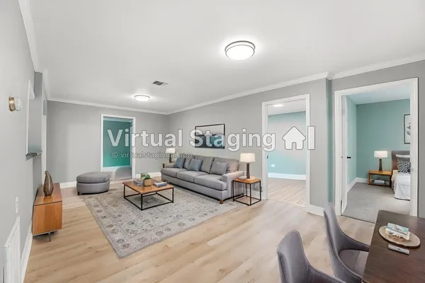 a living room with furniture and a wooden floor