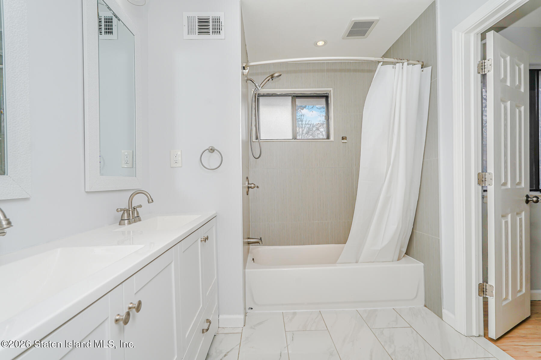 1818 Forest Hill Road Staten Island, NY 10306 - Photo 20 of 36 a bathroom with a bathtub and a sink