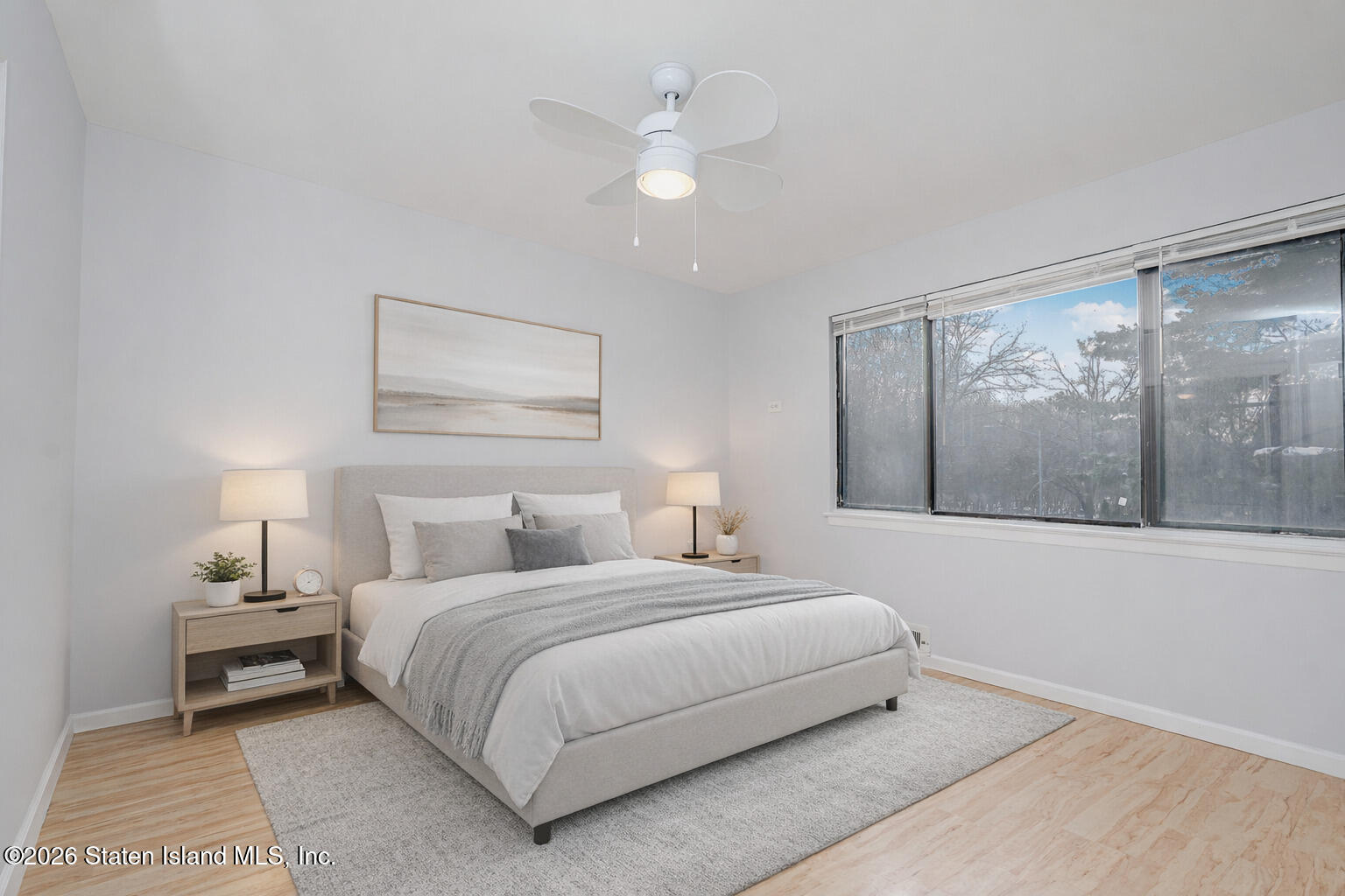 1818 Forest Hill Road Staten Island, NY 10306 - Photo 24 of 36 a bedroom with a large bed and a painting on the wall