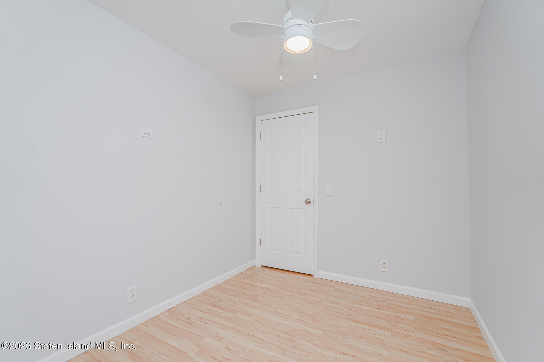 1818 Forest Hill Road Staten Island, NY 10306 - Photo 26 of 36 a view of an empty room with wooden floor