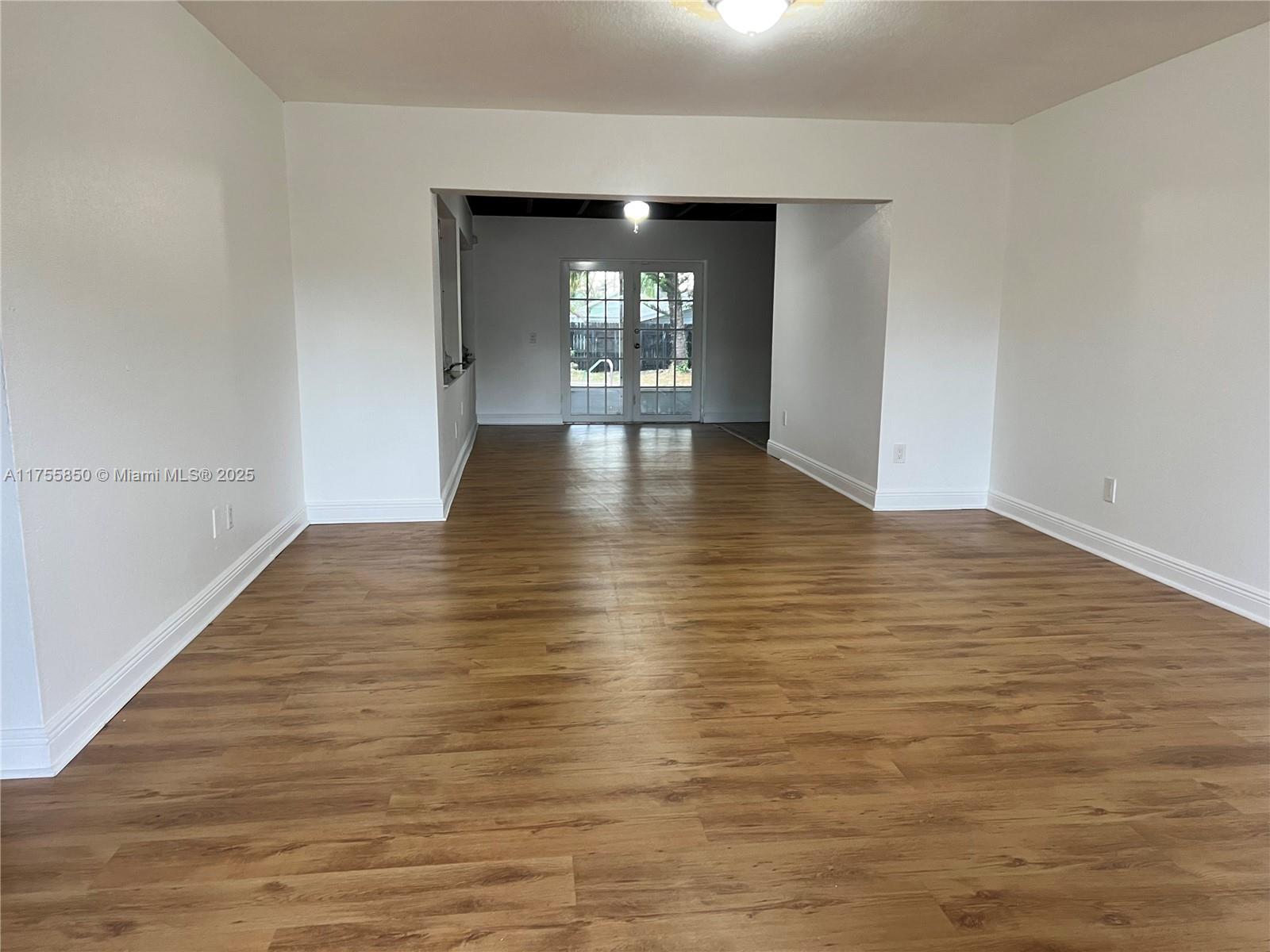 480 Northwest 16th Street Homestead, FL 33030 - Photo 5 of 14 wooden floor in an empty room with a window