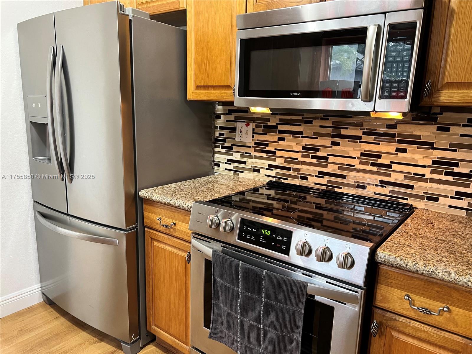 480 Northwest 16th Street Homestead, FL 33030 - Photo 6 of 14 a kitchen with a stove microwave and refrigerator