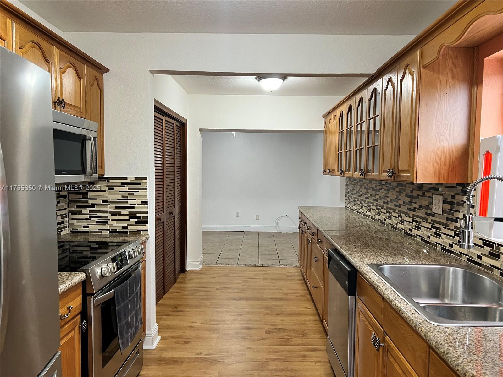 480 Northwest 16th Street Homestead, FL 33030 - Photo 7 of 14 a kitchen with a sink stove and refrigerator