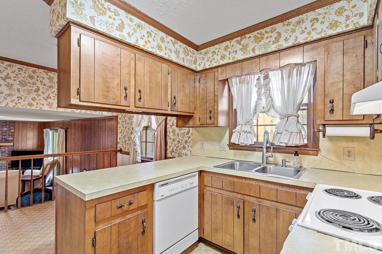 241 Fairview Road Cary, NC 27511 - Photo 12 of 34 a kitchen with a stove a sink and a refrigerator