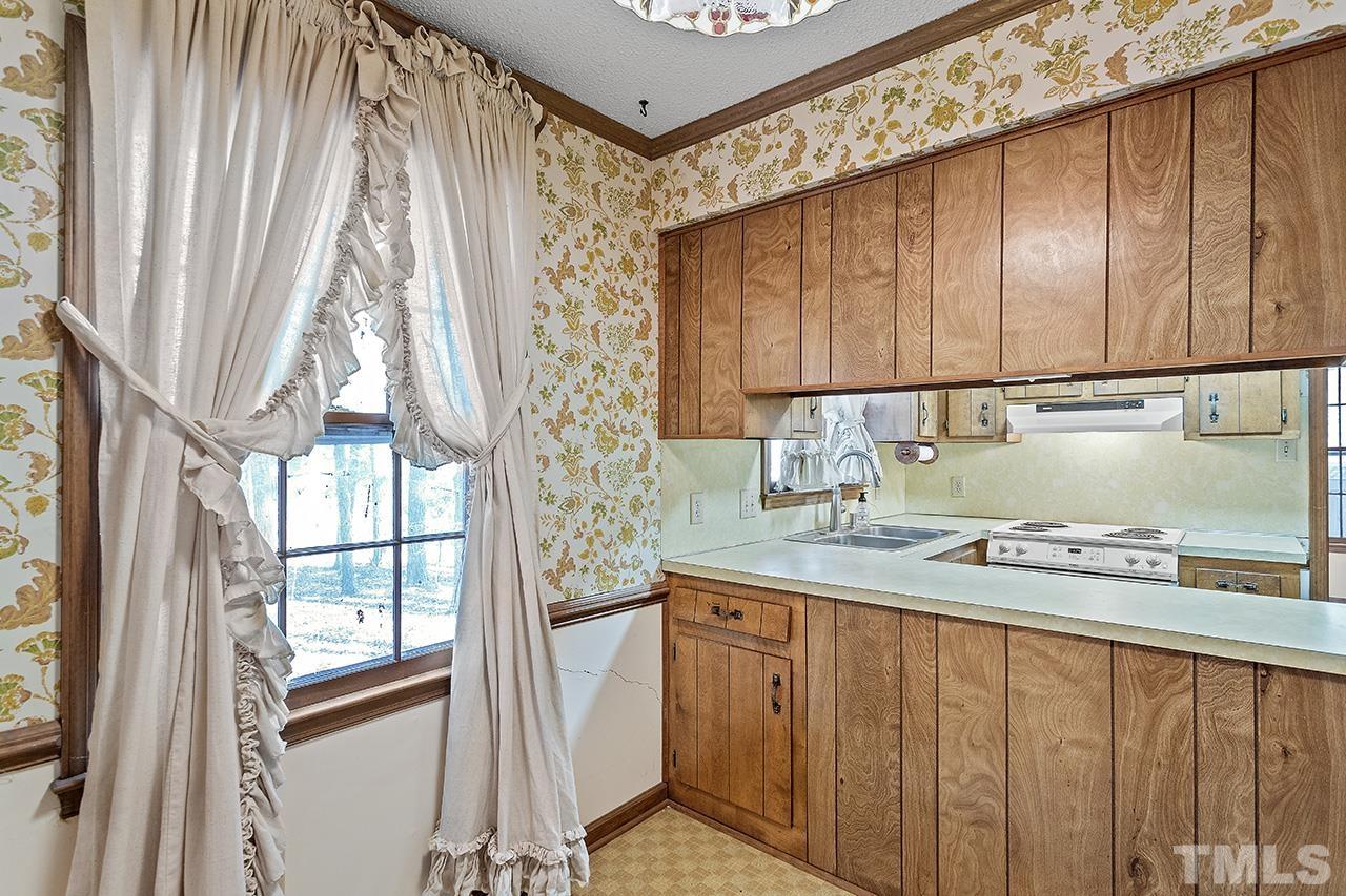 241 Fairview Road Cary, NC 27511 - Photo 13 of 34 a kitchen with stainless steel appliances granite countertop a sink a stove and a refrigerator