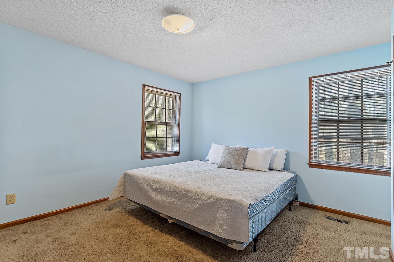 241 Fairview Road Cary, NC 27511 - Photo 19 of 34 a bedroom with a bed and window
