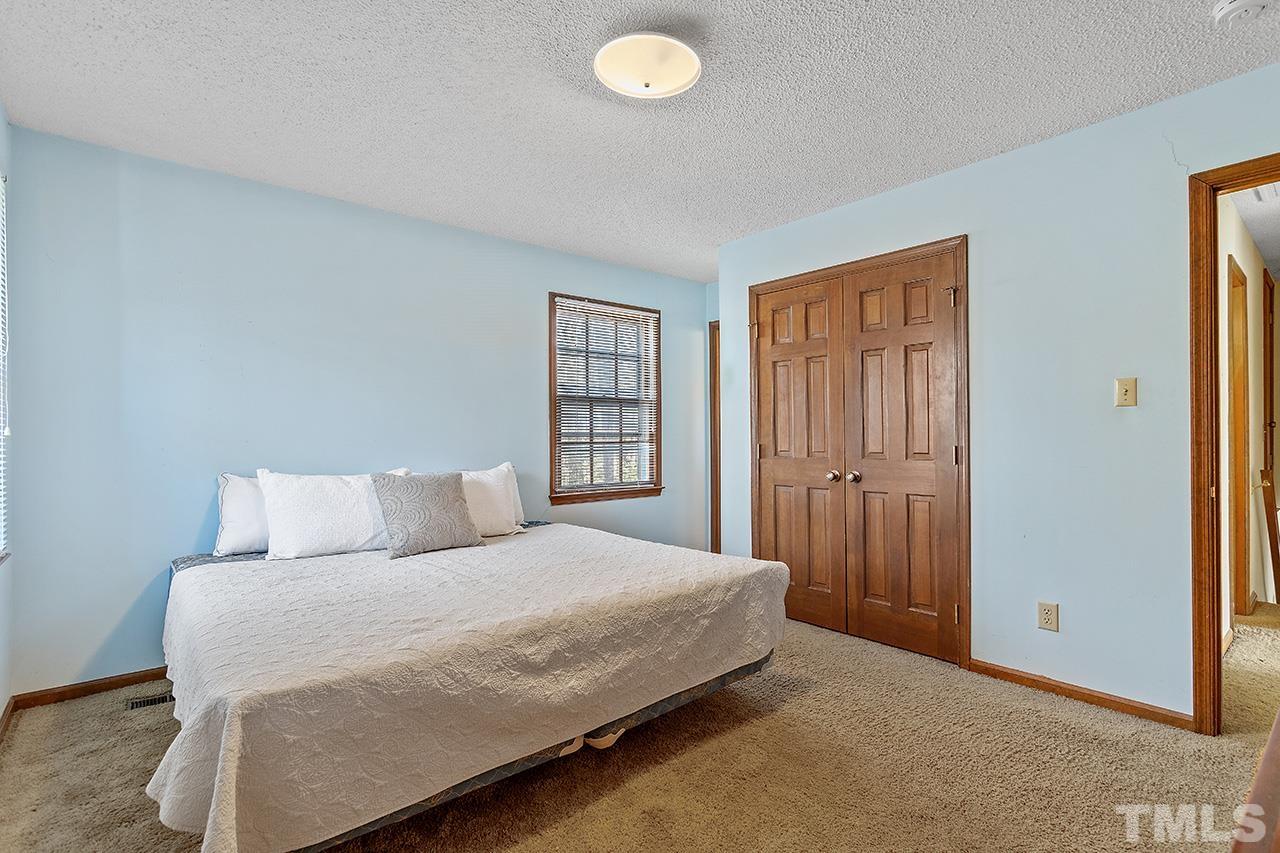 241 Fairview Road Cary, NC 27511 - Photo 20 of 34 a bedroom with a bed and a window