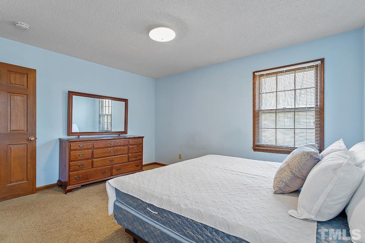 241 Fairview Road Cary, NC 27511 - Photo 21 of 34 a bedroom with a bed and a dresser