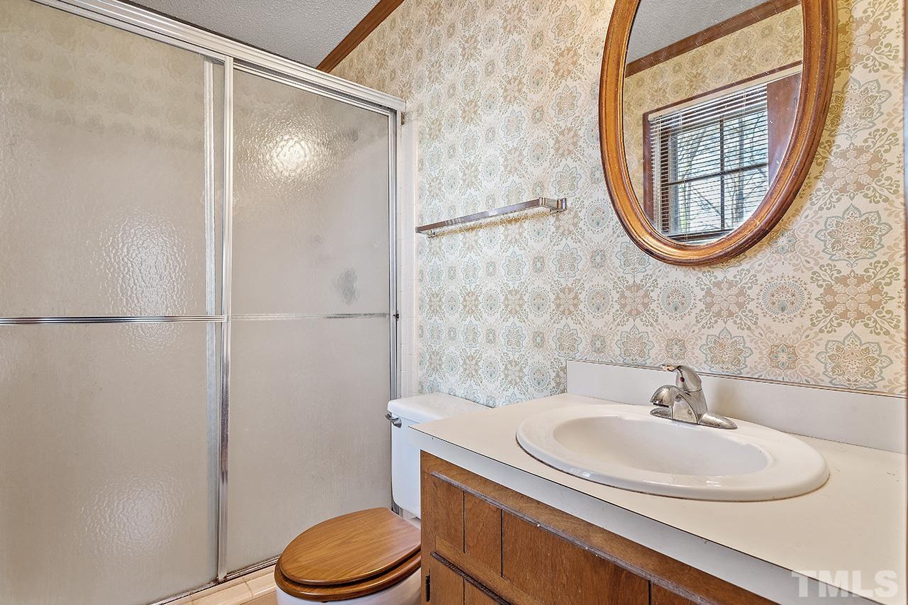 241 Fairview Road Cary, NC 27511 - Photo 22 of 34 a bathroom with a sink toilet and a mirror