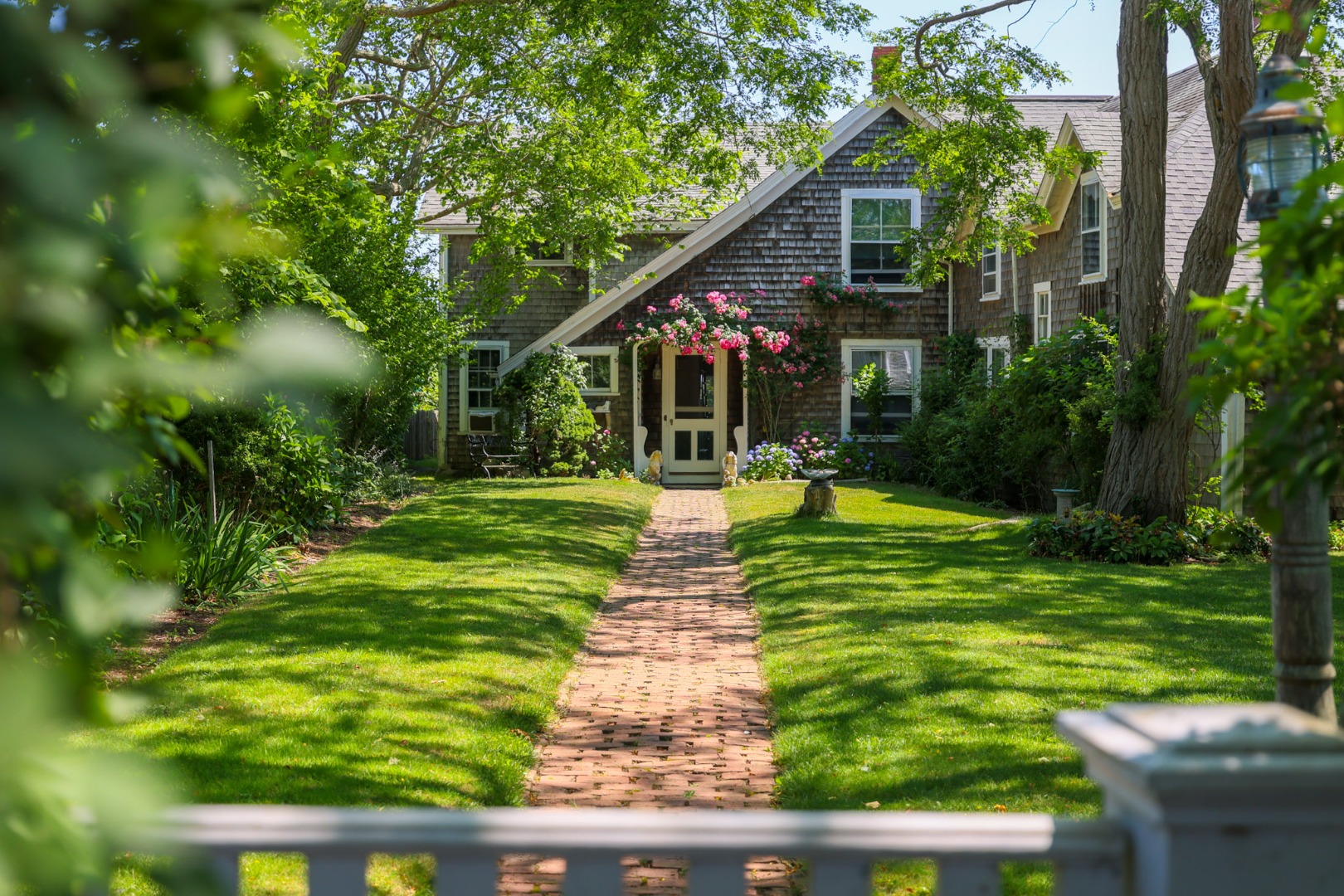 13 Cliff Road Nantucket, MA 02554 - Photo 1 of 38 a front view of a house with garden