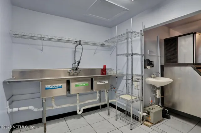 a kitchen with cabinets and chairs