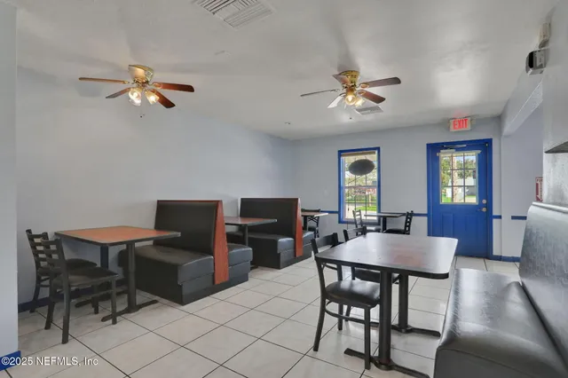 an outdoor sitting area with furniture and umbrella