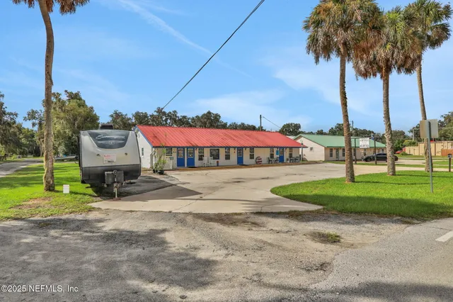 an aerial view of a city with lots of residential buildings and mountain view in back