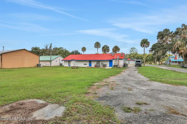 an aerial view of residential houses with outdoor space and street view