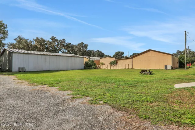 an aerial view of residential houses with outdoor space and street view