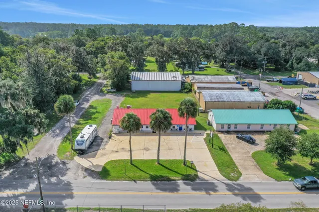 an aerial view of a house with a yard
