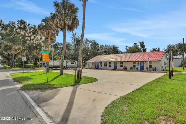 a sign board with a play ground in front of the house
